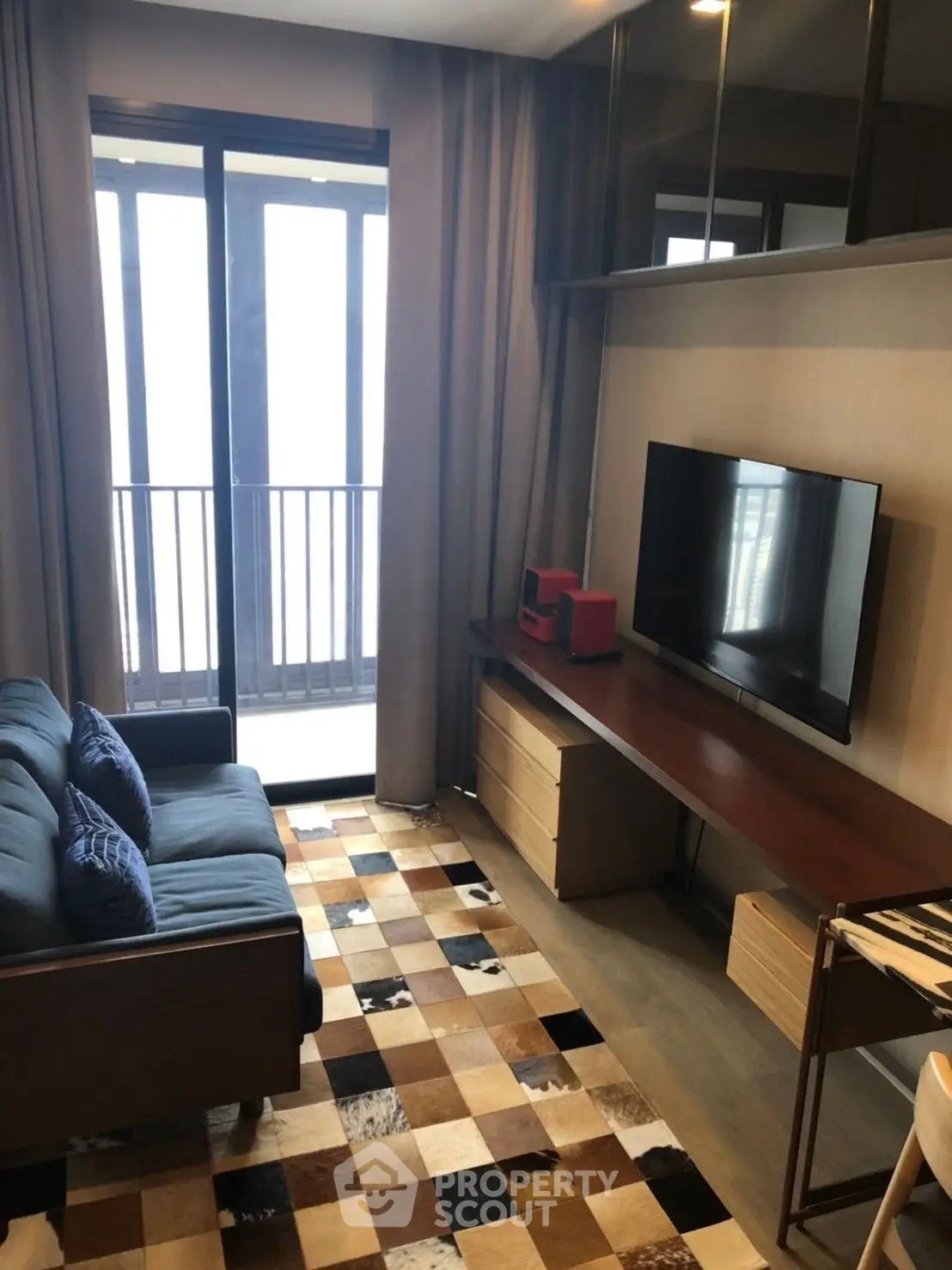 Modern living room with stylish decor and balcony view