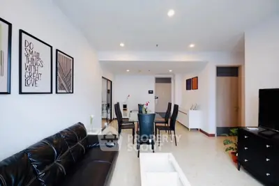 Spacious modern living room with sleek black furniture and stylish decor