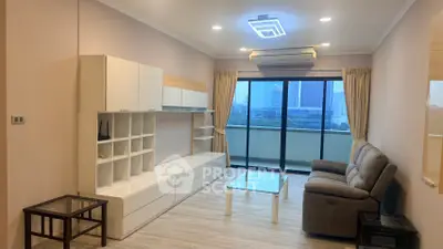 Modern living room with sleek furniture and city view balcony, perfect for urban living.