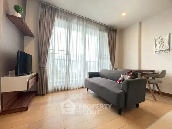 Modern living room with sleek furniture and large window for natural light