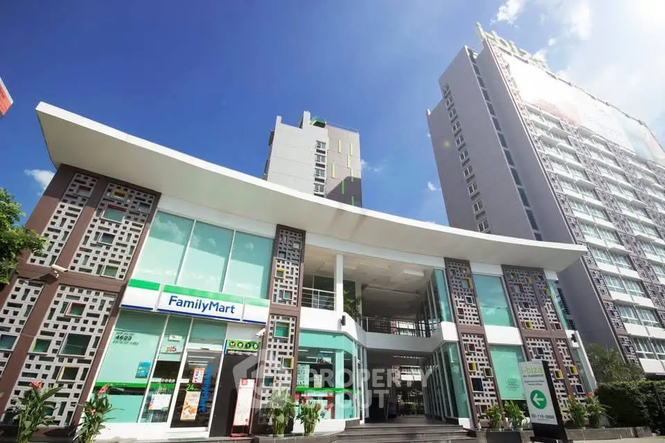 Modern commercial building with retail store and high-rise residential tower