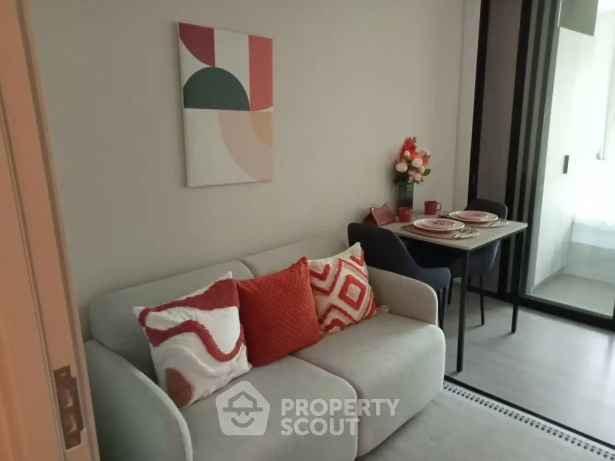 Cozy living room with modern decor and dining area, perfect for urban living.