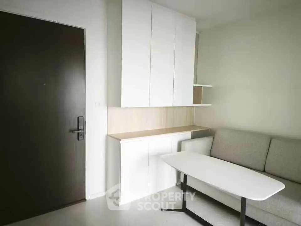 Modern living room with sleek furniture and built-in storage cabinets