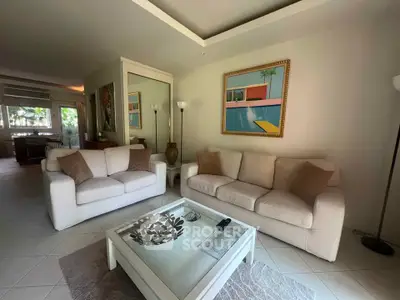 Spacious living room with modern decor and large windows offering natural light.