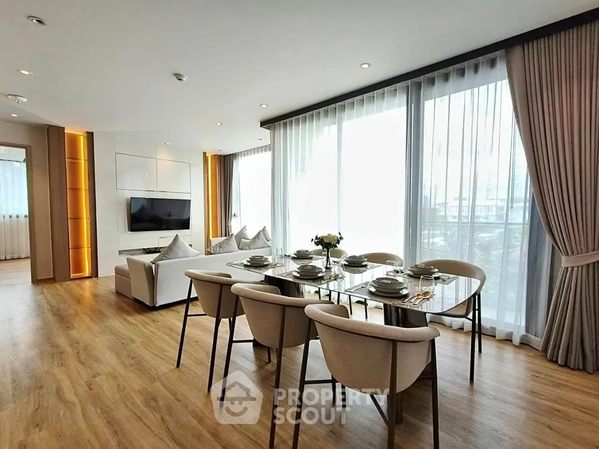 Spacious modern living room with elegant dining area and large windows