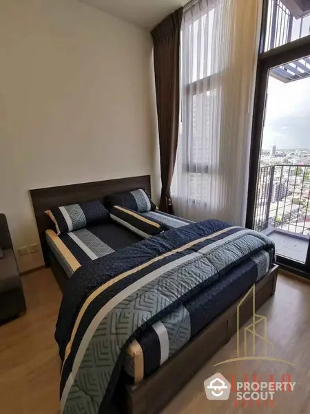 Cozy bedroom with a comfortable double bed and large window offering a panoramic city view, complete with elegant drapery and modern furnishings.