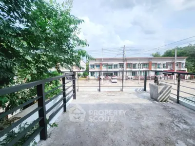 Spacious balcony with urban view and greenery, perfect for relaxation.