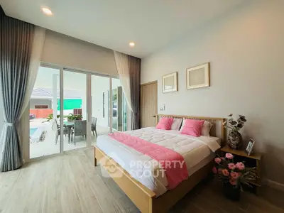 Spacious bedroom with pool view and elegant decor