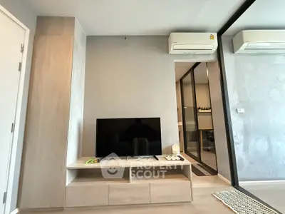 Modern living room with sleek TV stand and dual air conditioning units