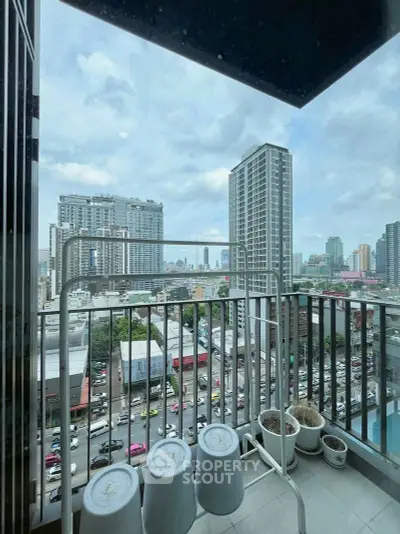 Urban balcony with city skyline view, perfect for relaxation and enjoying the vibrant cityscape.