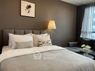 Luxurious bedroom with elegant decor and cozy seating area, perfect for relaxation and comfort.