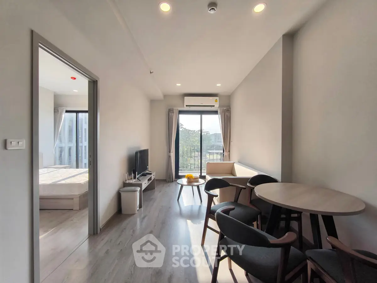 Modern living room with natural light, stylish furniture, and balcony view in a contemporary apartment.