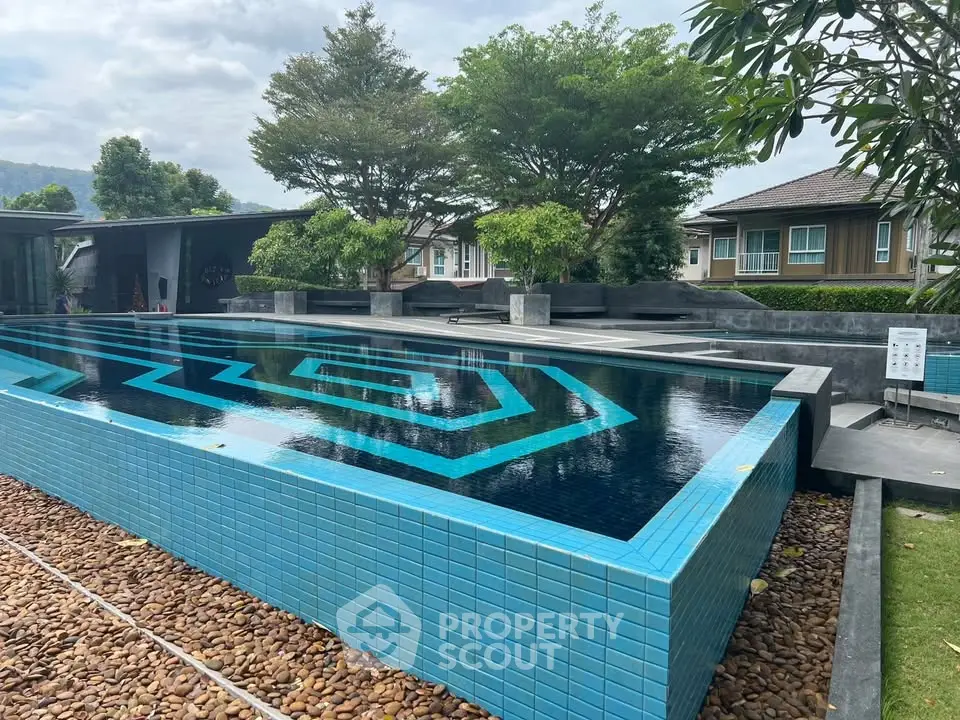 Luxurious modern pool with geometric design in serene residential setting