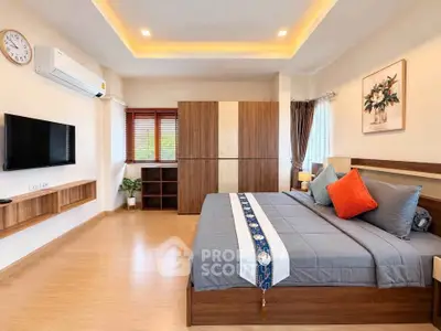 Spacious modern bedroom with stylish decor and ample natural light