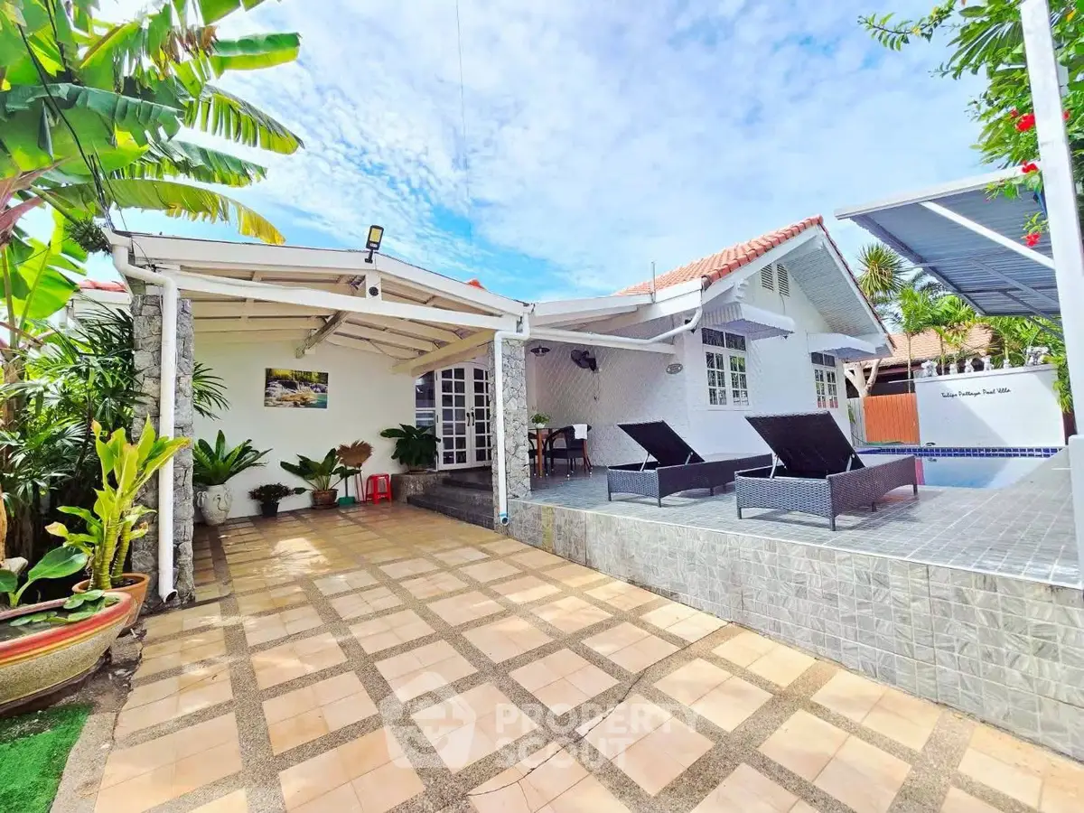 Charming villa with spacious patio and pool, perfect for outdoor relaxation.