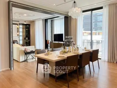 Luxurious open-plan dining and living area with elegant decor and large windows.