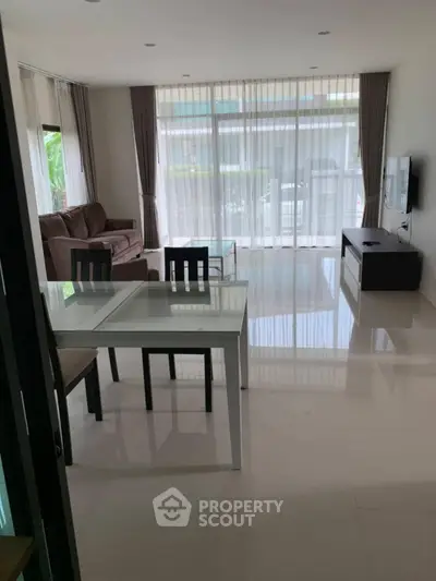 Spacious living room with modern furniture and large windows for natural light.