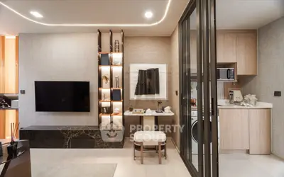 Modern living room with sleek TV setup and compact kitchen area