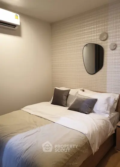 Cozy bedroom with modern decor and stylish wall mirror