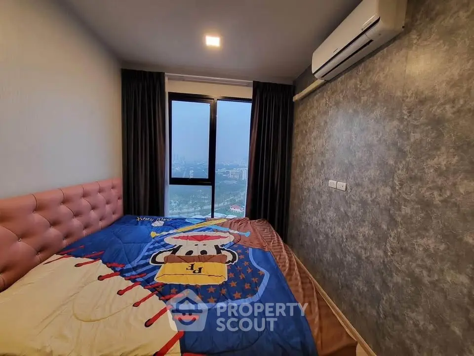 Cozy bedroom with city view, featuring modern decor and air conditioning.