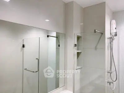 Modern bathroom with glass shower and sleek fixtures