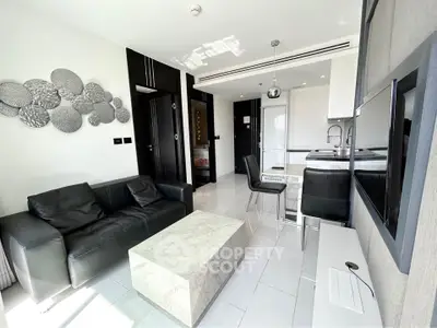 Modern living room with sleek black sofa and marble coffee table in bright apartment