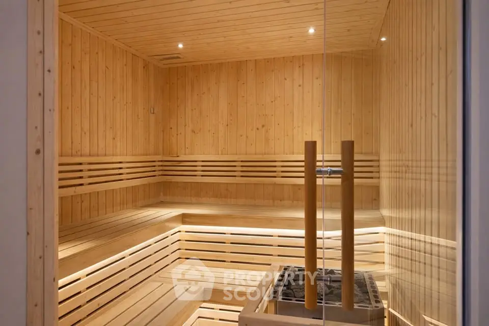 Luxurious wooden sauna room with ambient lighting and modern design.