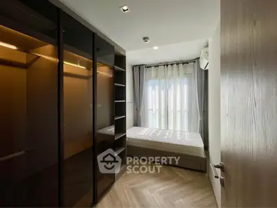 Modern bedroom with sleek wardrobe and natural light