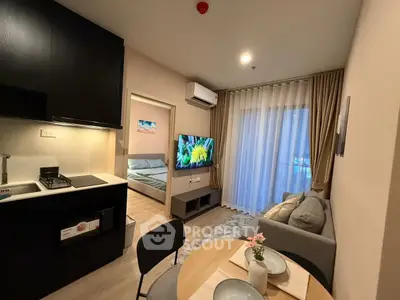 Modern open-plan living room with cozy dining area and stylish kitchen in a contemporary apartment.