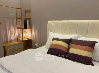 Cozy bedroom with stylish decor and soft lighting, perfect for relaxation.