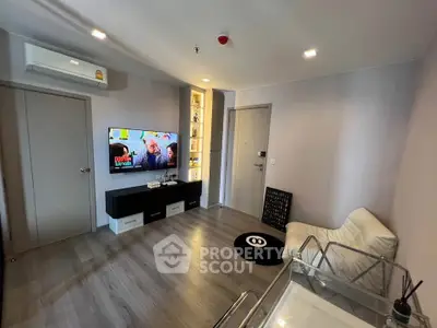 Modern living room with sleek design and wall-mounted TV in a stylish apartment.