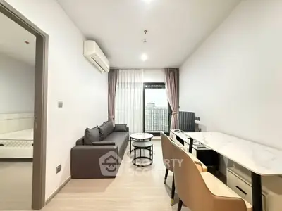 Modern living room with sleek furniture and city view, perfect for urban living.