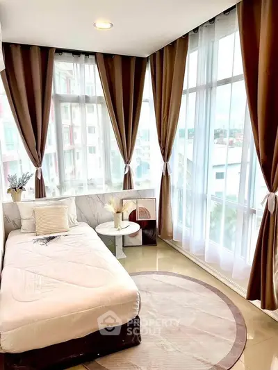 Bright bedroom with large windows and elegant curtains in modern apartment