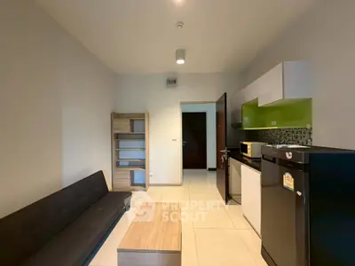 Modern studio apartment with sleek kitchen and cozy living area, perfect for urban living.