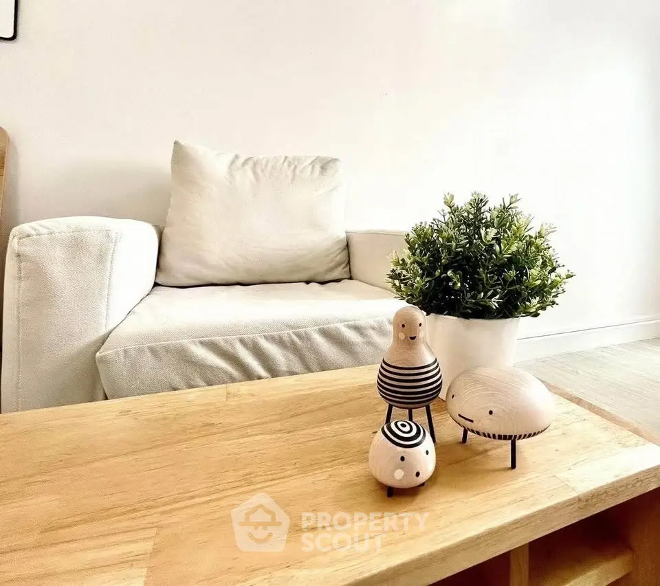 Stylish living room with cozy white sofa and wooden coffee table, perfect for modern living.