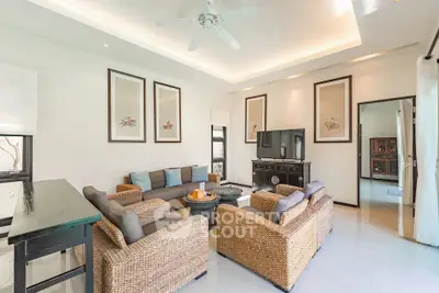 Spacious living room with elegant decor and natural light, featuring comfortable seating and modern design.