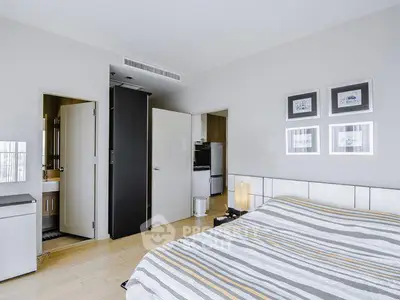 Modern bedroom with ensuite bathroom and stylish decor in a contemporary apartment.