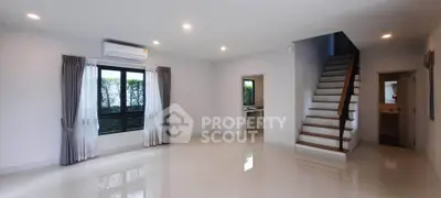 Spacious modern living room with staircase and large windows