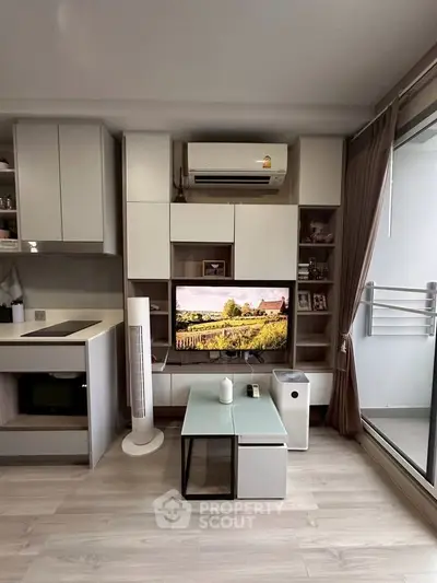 Modern living room with sleek storage, air conditioning, and balcony access.