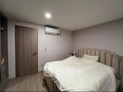 Cozy bedroom with modern air conditioning and plush bedding