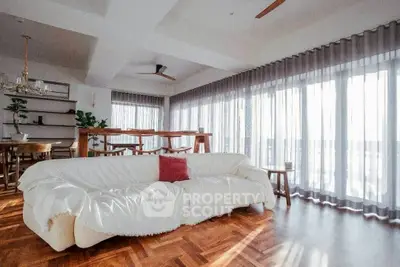 Spacious living room with elegant decor and large windows for natural light.