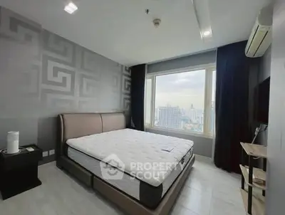 Modern bedroom with city view, featuring stylish decor and large window for natural light.
