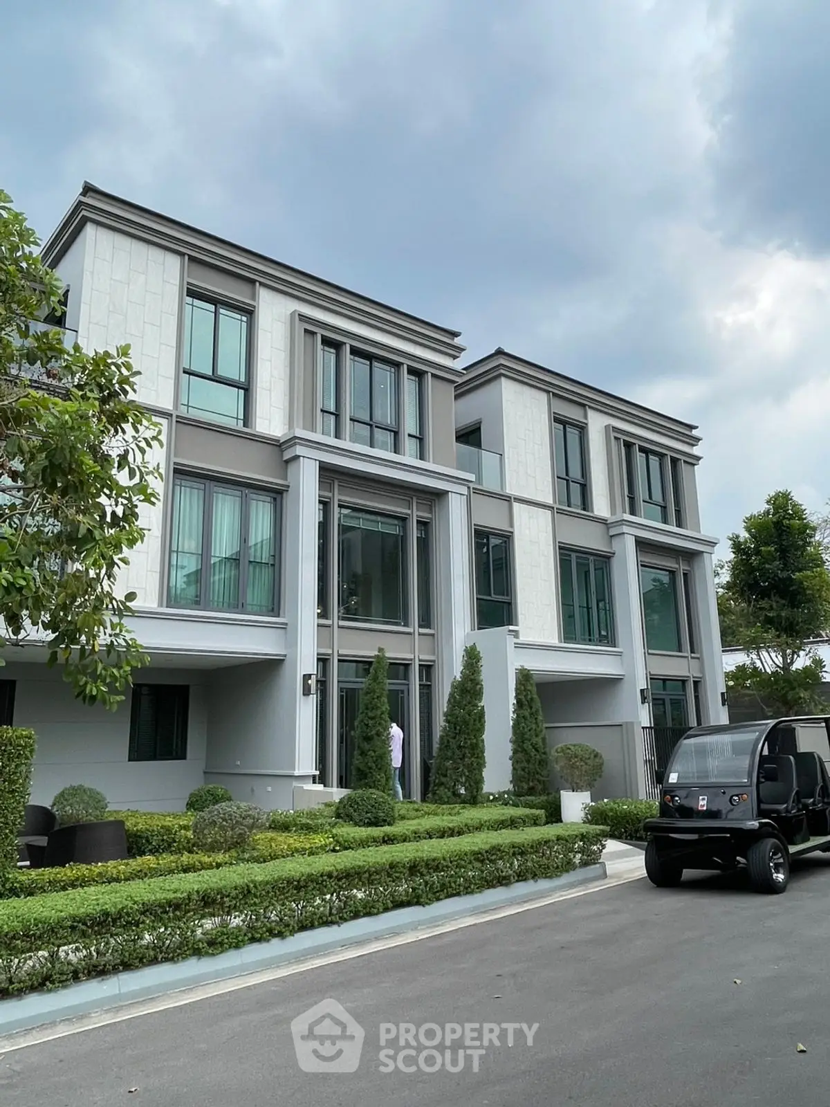 Luxurious modern townhouse with sleek design and lush landscaping