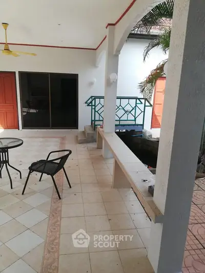 Charming patio with tiled flooring and outdoor seating, perfect for relaxation and entertaining.