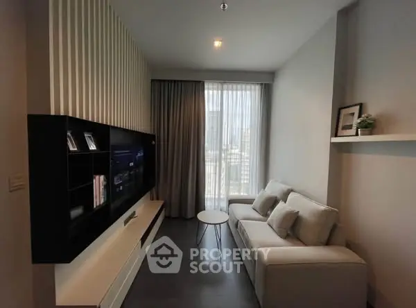 Modern living room with sleek TV unit and cozy sofa, perfect for relaxation.