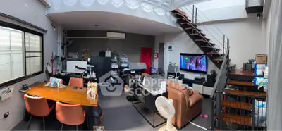 Spacious modern living room with loft design, featuring stylish furniture and open layout for comfortable living.