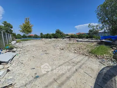 Vacant land plot with clear blue sky, ideal for development opportunities.
