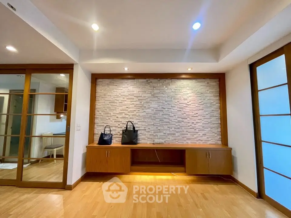 Spacious modern living room with wooden flooring and stylish wall design