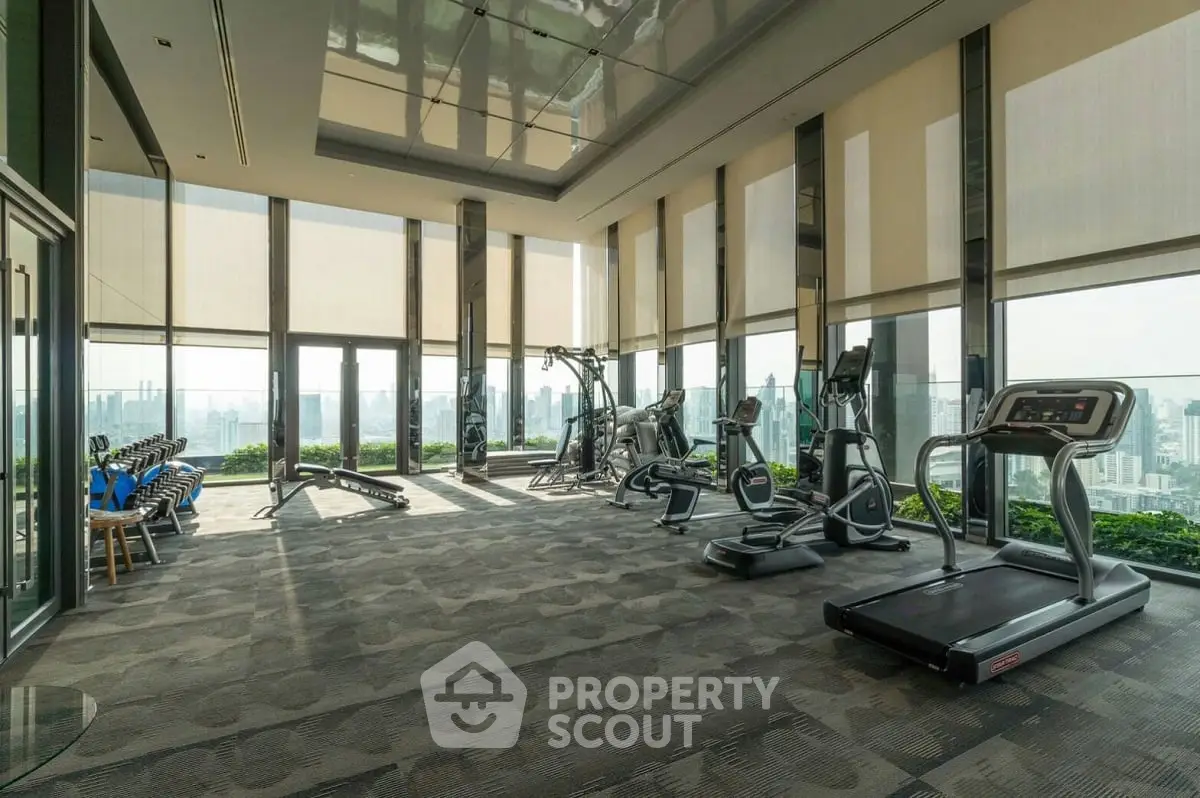 Luxurious high-rise gym with panoramic city views and modern fitness equipment.