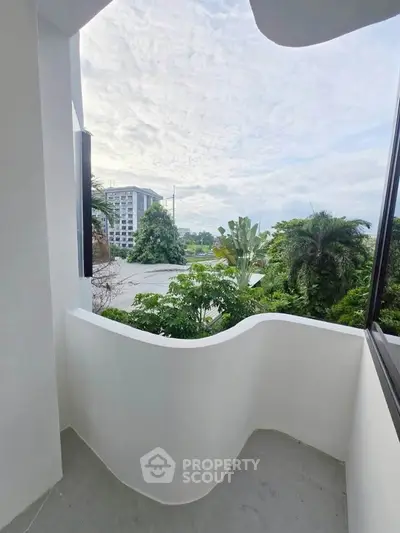 Charming balcony with lush greenery and scenic view, perfect for relaxation and enjoying nature.